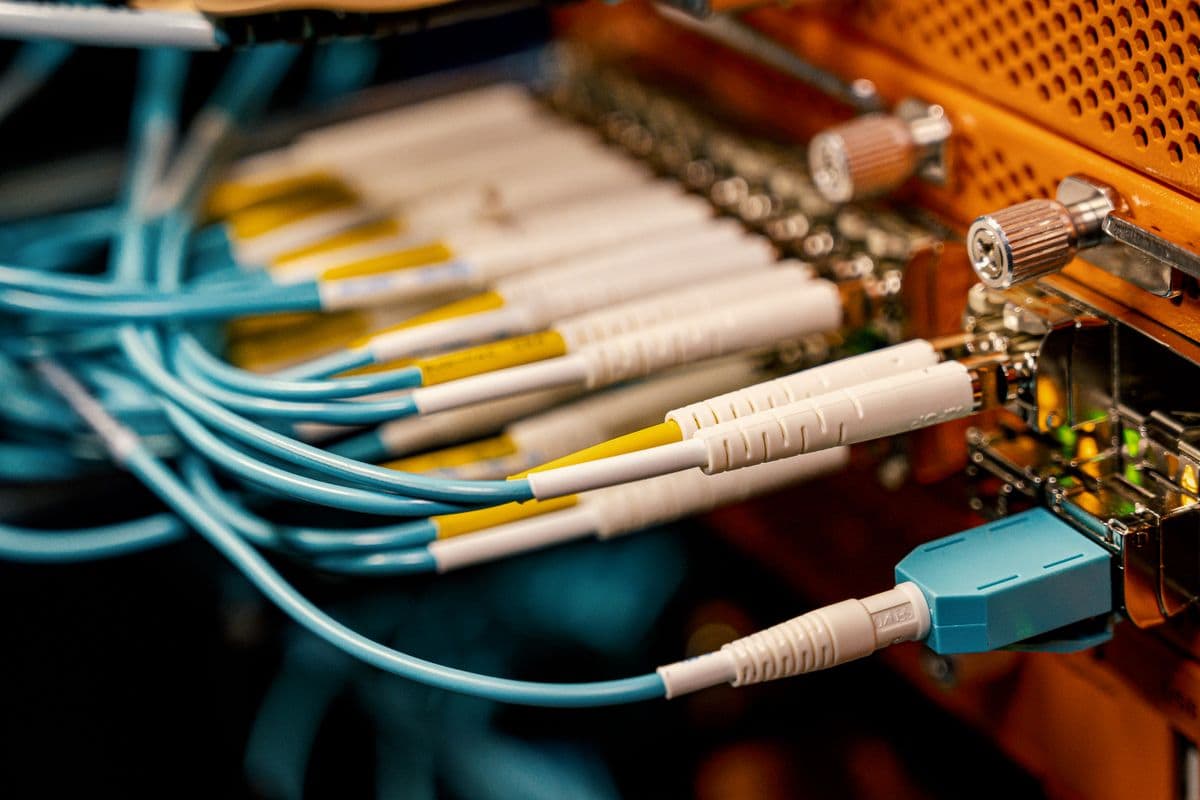 Vista cenital de switch con puertos SFP y conectores de fibra óptica LC conectados, típico de un nodo de distribución en datacenter